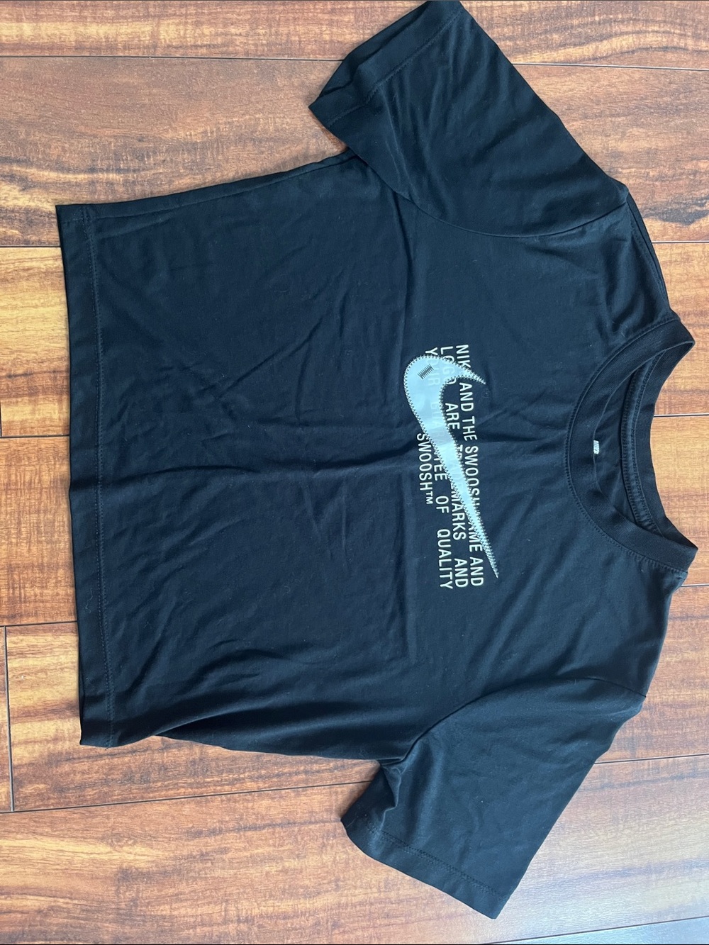 Nike Black Short-Sleeve Graphic Crop Tee with White Swoosh Accent